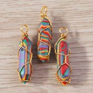 Macro detail of wire-wrapped hexagonal crystal pendants with vibrant rainbow stripes