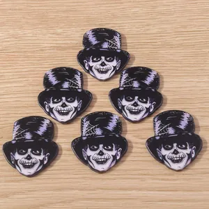 Macro shot of 6 acrylic skeleton head pendants with purple hats for DIY jewelry