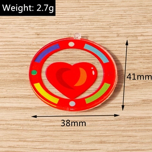 Detail view of round acrylic heart pendant with dimensions and weight on wood background