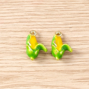 Detail of creative corn-shaped enamel pendants with gold loops for DIY jewelry making