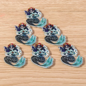Detailed macro view of Day of the Dead style acrylic skeleton mermaid jewelry charms