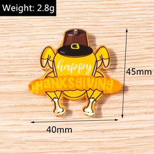 Macro view of a 45mm yellow acrylic turkey pendant with happy thanksgiving text