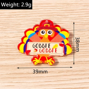 Detail view of colorful acrylic turkey pendant with Gobble Gobble sign for DIY jewelry