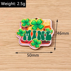 Detailed view of St. Patrick's Day green clover acrylic pendant with MINE lettering