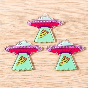 Detail of creative acrylic UFO and pizza pendants with semi-transparent green light beams