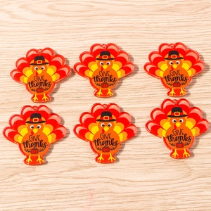 Macro view of six Thanksgiving turkey acrylic pendants with Give Thanks engraving