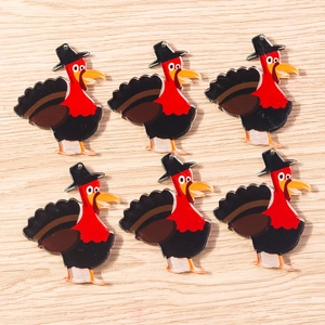 Close-up of six turkey acrylic pendants with hanging holes on a wooden background
