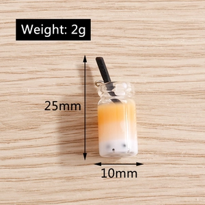 Macro shot showing dimensions of 25mm mini bubble tea charms with metallic hooks