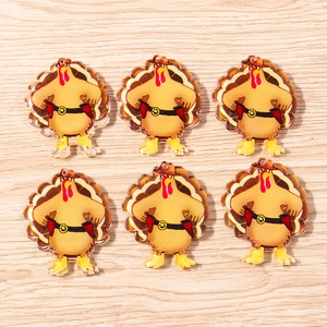Detail of 6 acrylic cowboy turkey charms for Thanksgiving DIY jewelry on wood background