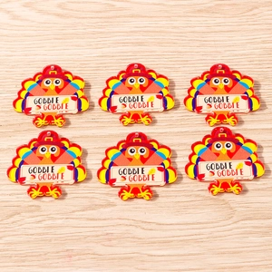 Close-up of colorful acrylic Thanksgiving turkey charms with Gobble Gobble text