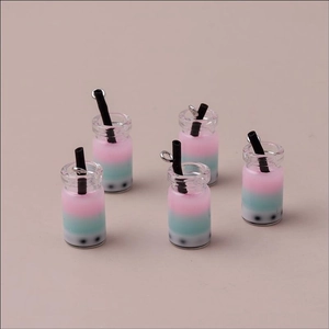 Detail view of five gradient bubble tea pendants with resin pearls and metal rings