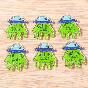 Detailed macro of acrylic UFO pendants with 'GET IN, LOSER.' text and green light beam