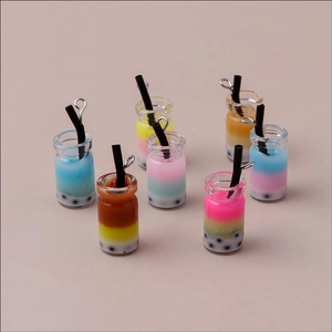 Close-up of colorful resin bubble tea charms with metal rings for DIY jewelry