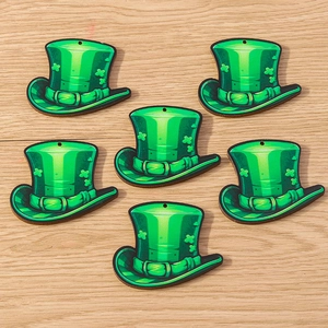Macro view of green top hat charms with shamrock for St. Patrick's Day DIY jewelry