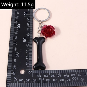 Detailed view of rose flower keychain with bone charm and size measurement scale