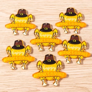 Detailed macro view of acrylic turkey pendants with Happy Thanksgiving lettering