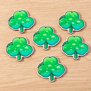 Detail showing six green clover wooden pendants with cartoon illustration style for DIY crafts