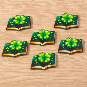 Close-up of green book-shaped clover charms for St. Patrick's Day DIY jewelry making