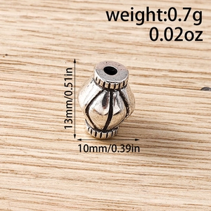 Detailed macro view of vintage silver lantern spacer bead showing weight and 13mm height