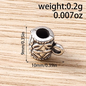 Macro detail of antique silver rhombus spacer bead with floral engraving and dimensions