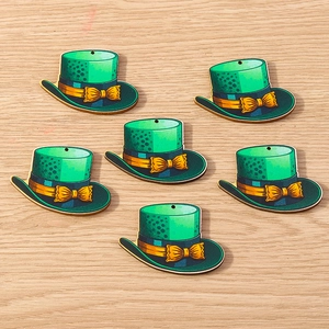 Detail of green Saint Patrick's Day top hat charms with gold bows and hanging holes