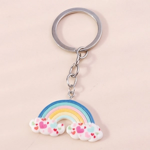Macro detail of cloud keychain with rainbow bridge and colorful heart pattern charm