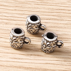 Close-up of antique silver flower pattern cup-shaped spacer beads for DIY jewelry making