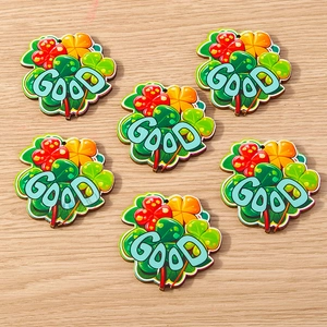 Detail of wooden three-leaf clover charms with GOOD text for DIY crafts jewelry making