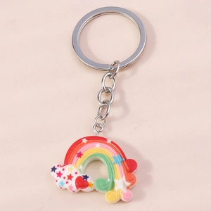 Detailed view of a colorful rainbow keychain with white clouds and a silver split key ring