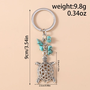 Detailed view of turtle keychain with turquoise stones and size measurements in cm and oz