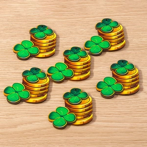 Close-up of Saint Patrick's Day shamrock and gold coin charms with pre-drilled holes