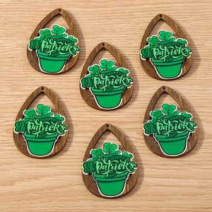 Flat lay of drop-shaped wooden shamrock pendants for St. Patrick's Day accessories