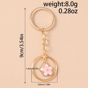 Detailed view of pink enamel cherry blossom keychain with size and weight measurements