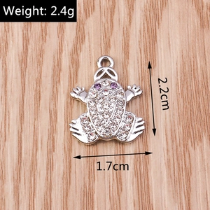 Detailed view of frog pendant with white and purple rhinestones, size 2.2x1.7cm