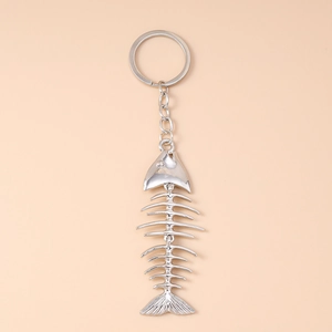 Detailed macro view of the silver metal fish bone keychain with movable segments