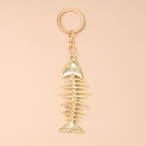 Detailed close-up of a gold-plated alloy fish bone keychain with movable segments