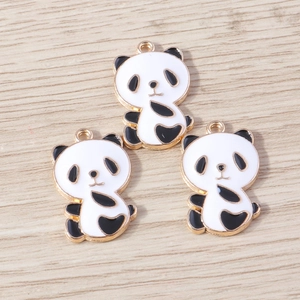 Detailed view of three cartoon panda enamel charms with gold metal base for DIY jewelry