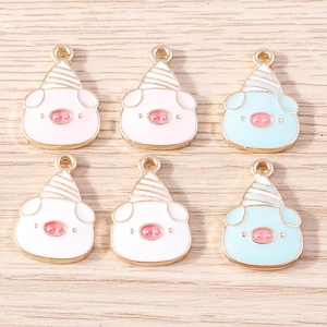 Detail view of colorful enamel cartoon pig pendants with party hats for DIY jewelry crafting