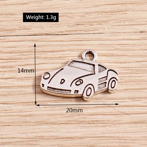 Macro view of vintage silver car pendants for DIY jewelry with precise size measurements