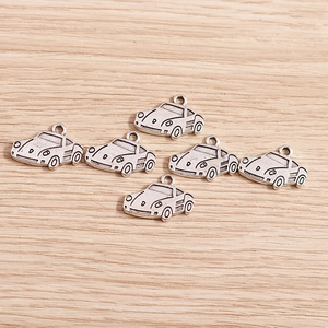 Detail of vintage silver beetle car charms for DIY bracelets with retro metal finish