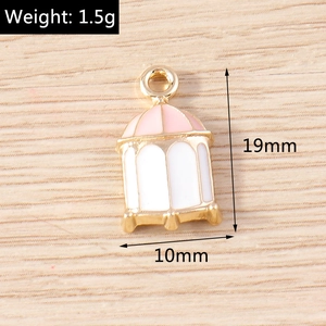 Detail of a birdcage-shaped gold alloy pendant with pink enamel and 19x10mm dimensions
