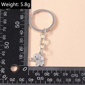 Silver elephant keychain with rhinestones and scale ruler showing 5.8g weight