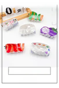 Set of six colorful acrylic hair claws with fruit and floral patterns in detail