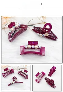 Detail view of burgundy hair claw with white pearls and sparkling rhinestones