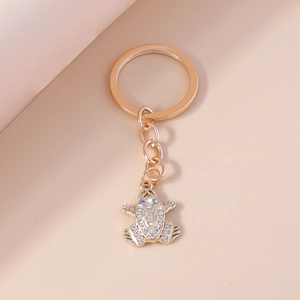 Detailed view of frog keychain with gold plating and sparkling white rhinestones