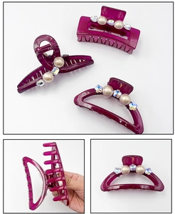 Detail of berry red hair claw clips with faux pearls and sparkling rhinestones