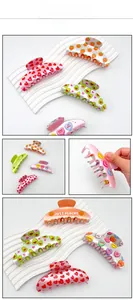Detailed view of acrylic shark hair claws with avocado, peach and heart prints
