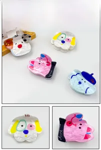 Detail of cute acrylic puppy hair claws showing pearlescent texture and various colors