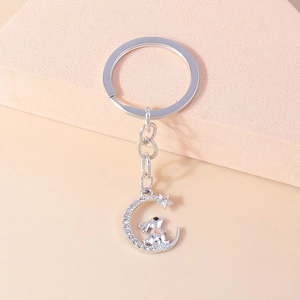 Detailed silver keychain with a rhinestone crescent moon, star, and cute rabbit pendant