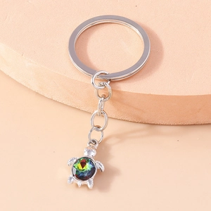 Detailed view of silver turtle keychain featuring a faceted Aurora Borealis crystal gem
